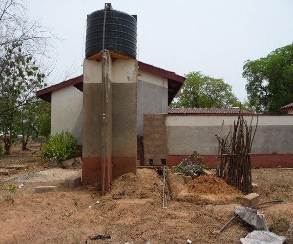 The polytanks near homes are filled with clean water.